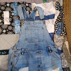 Distressed denim overalls